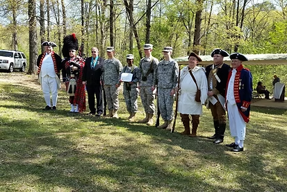 Group photo of soldiers and reenactors in park