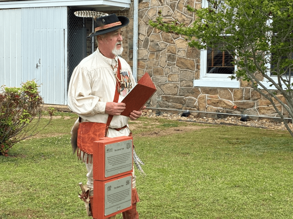 Two people dressed in historical costumes in a library.