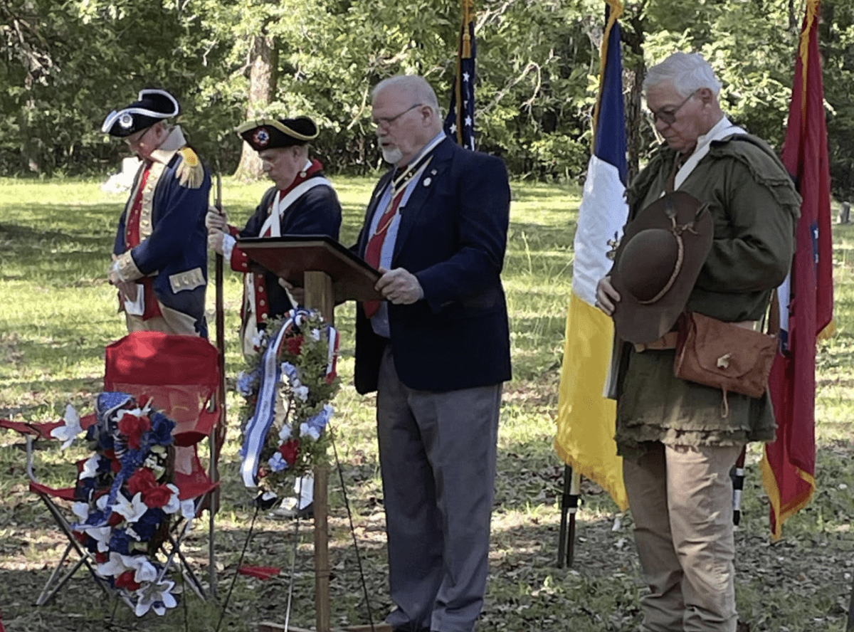 Men in historical uniforms at memorial ceremony